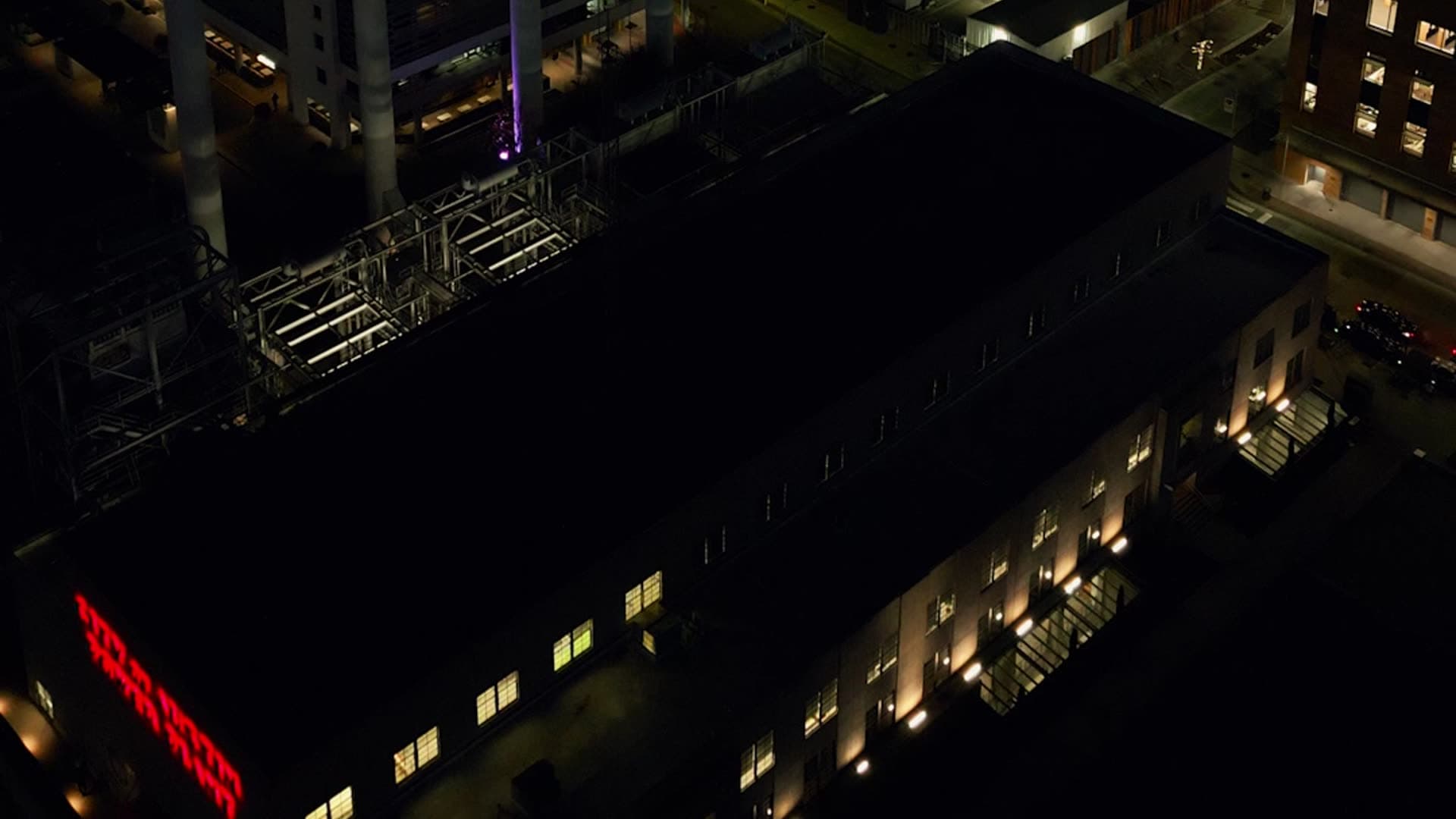 City buildings and rooftops at night seen from above