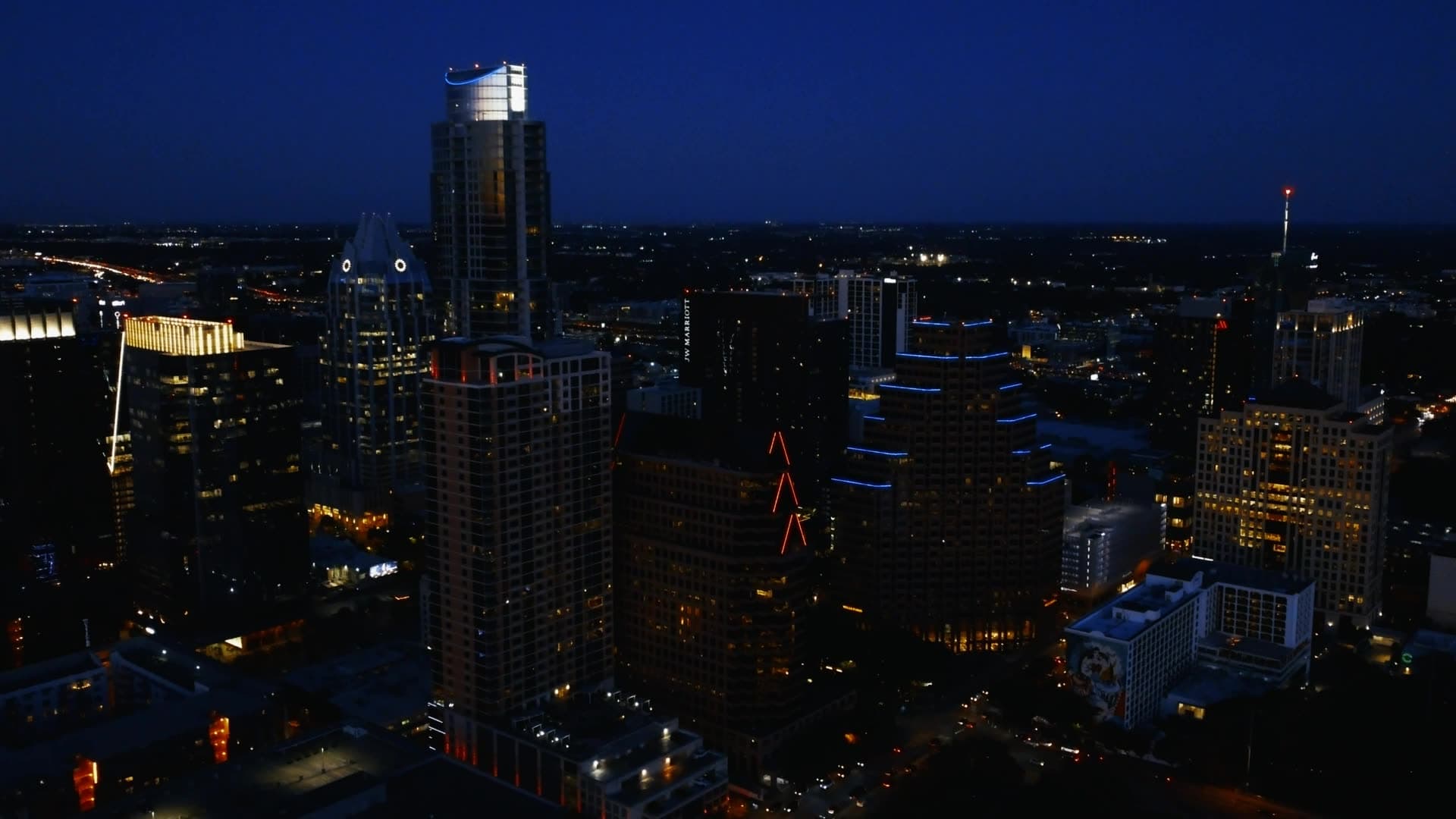 City skyline at blue hour with a tall illuminated tower