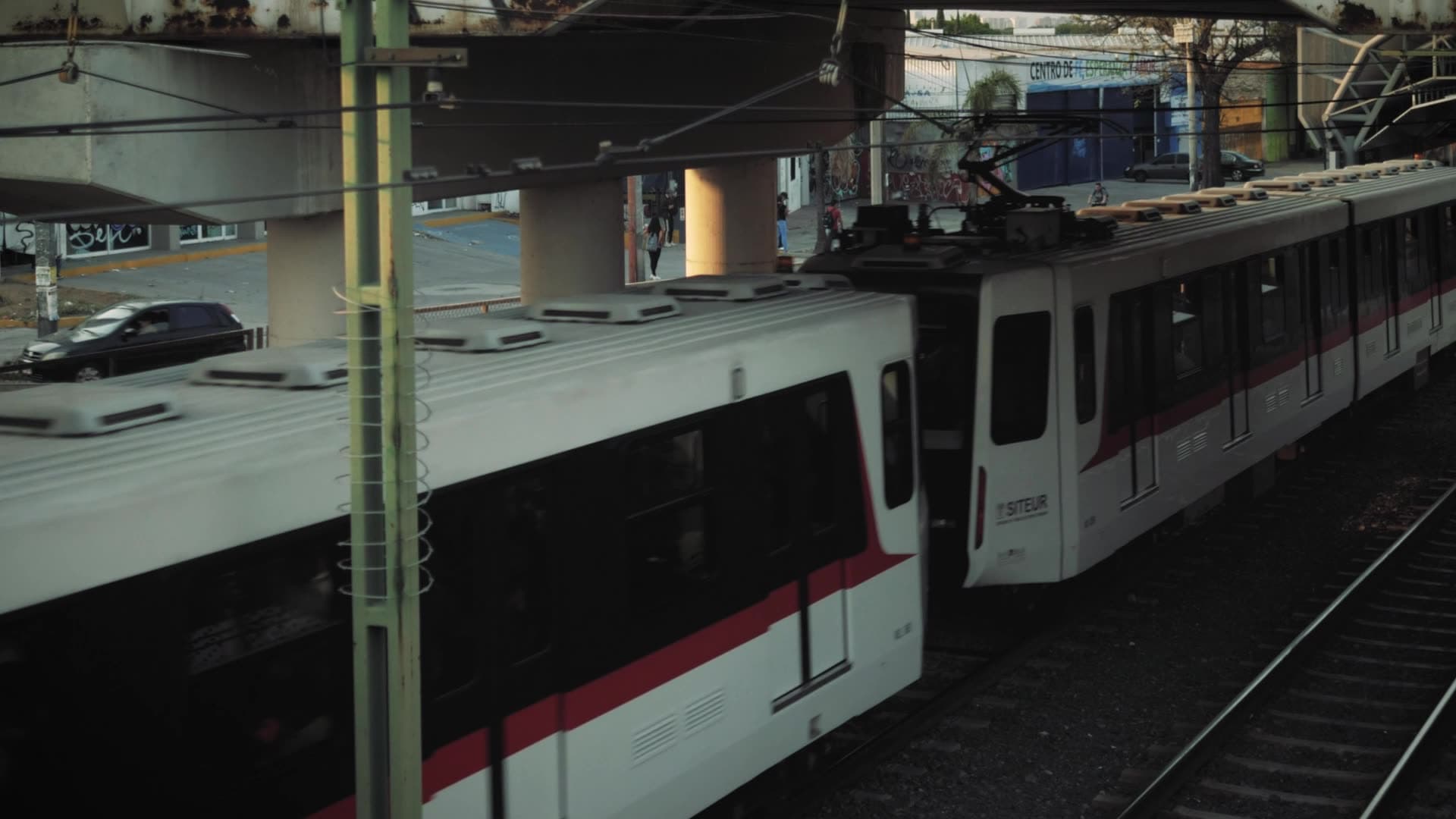 Commuter train moving through an elevated station