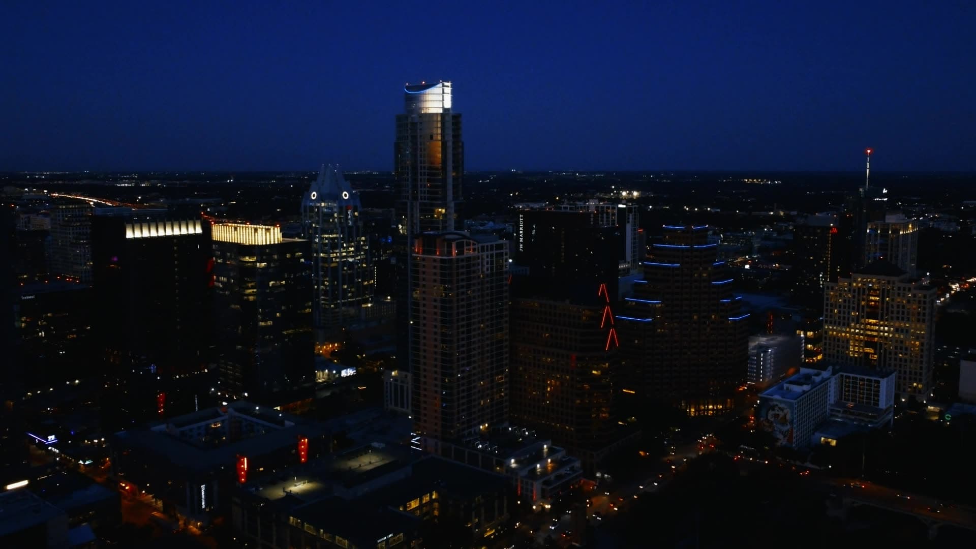 Night-time skyline with a tall illuminated tower