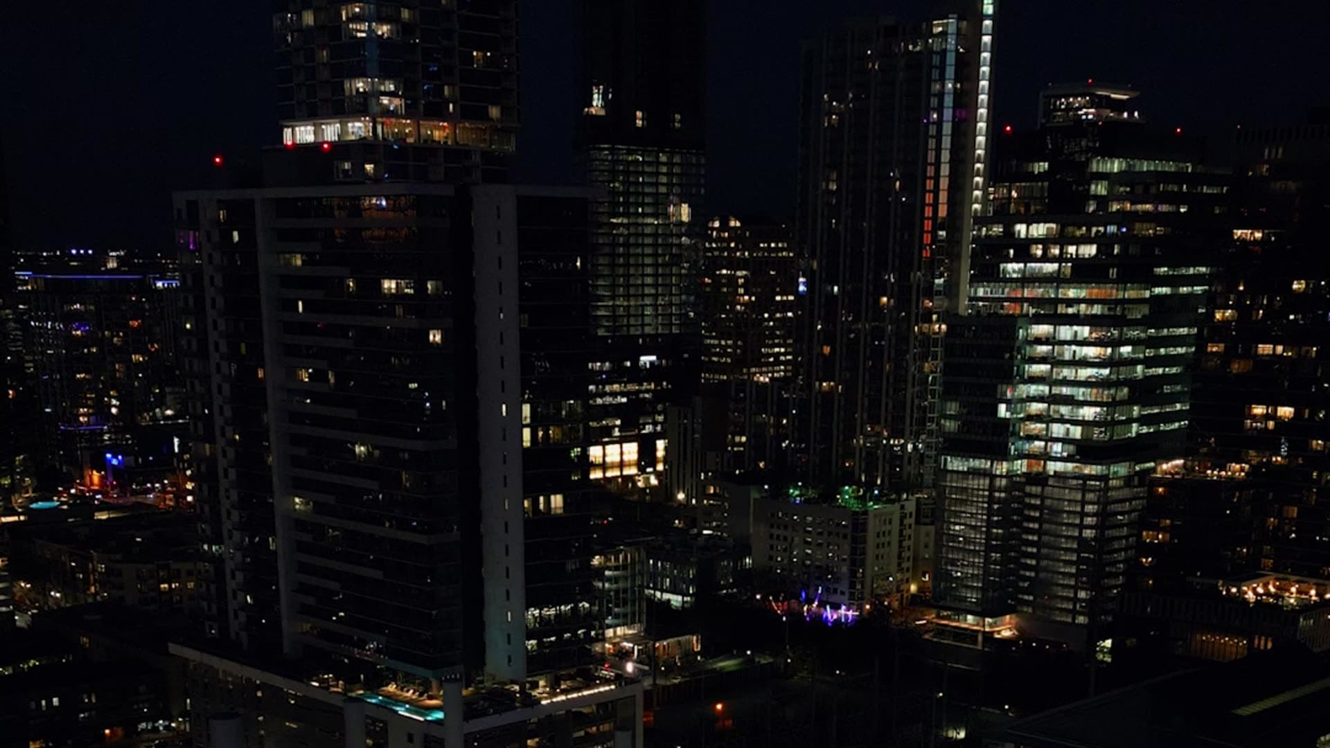 Office buildings and city lights seen from above at night