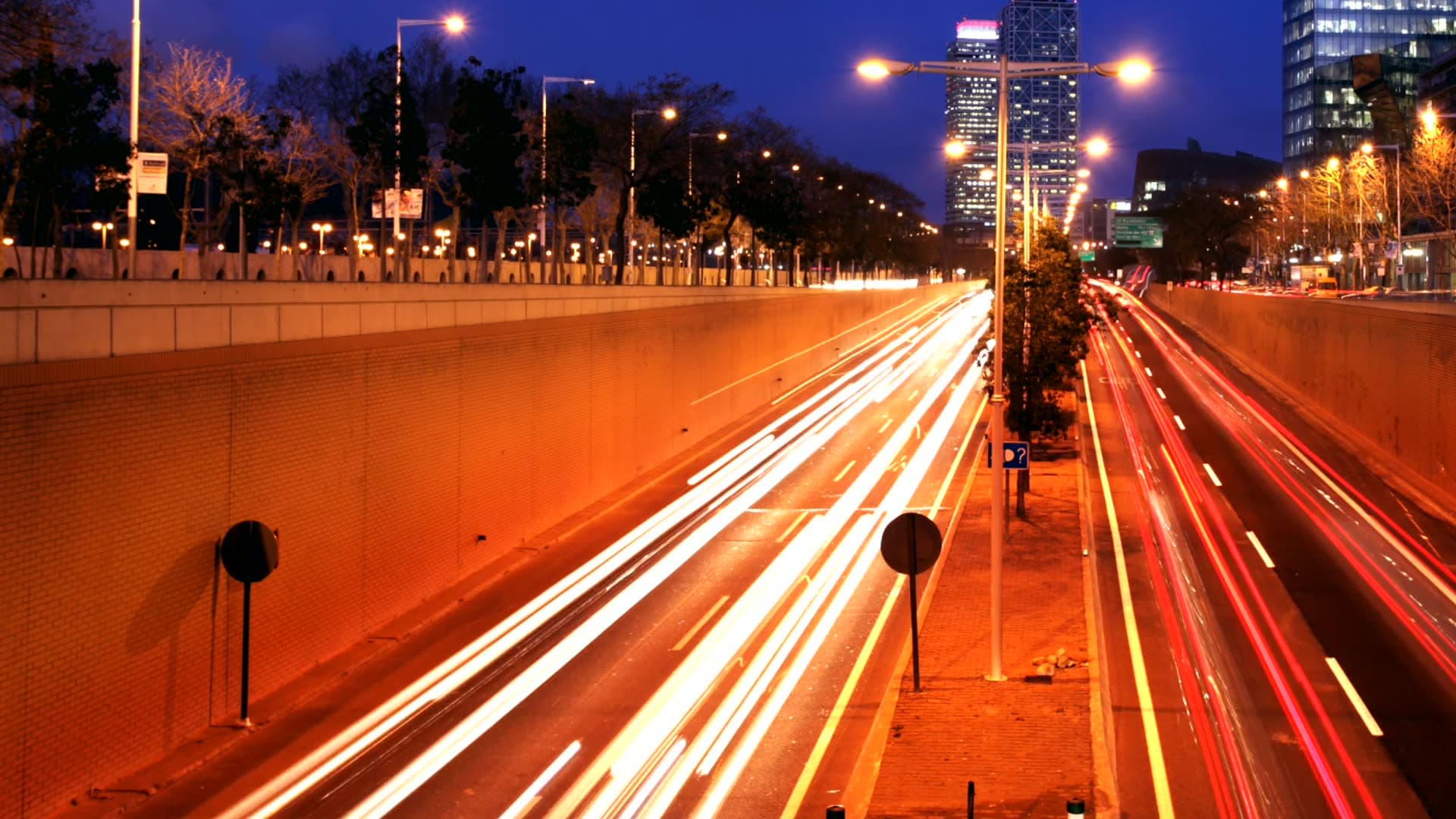 Long-exposure light trails of traffic on a city road