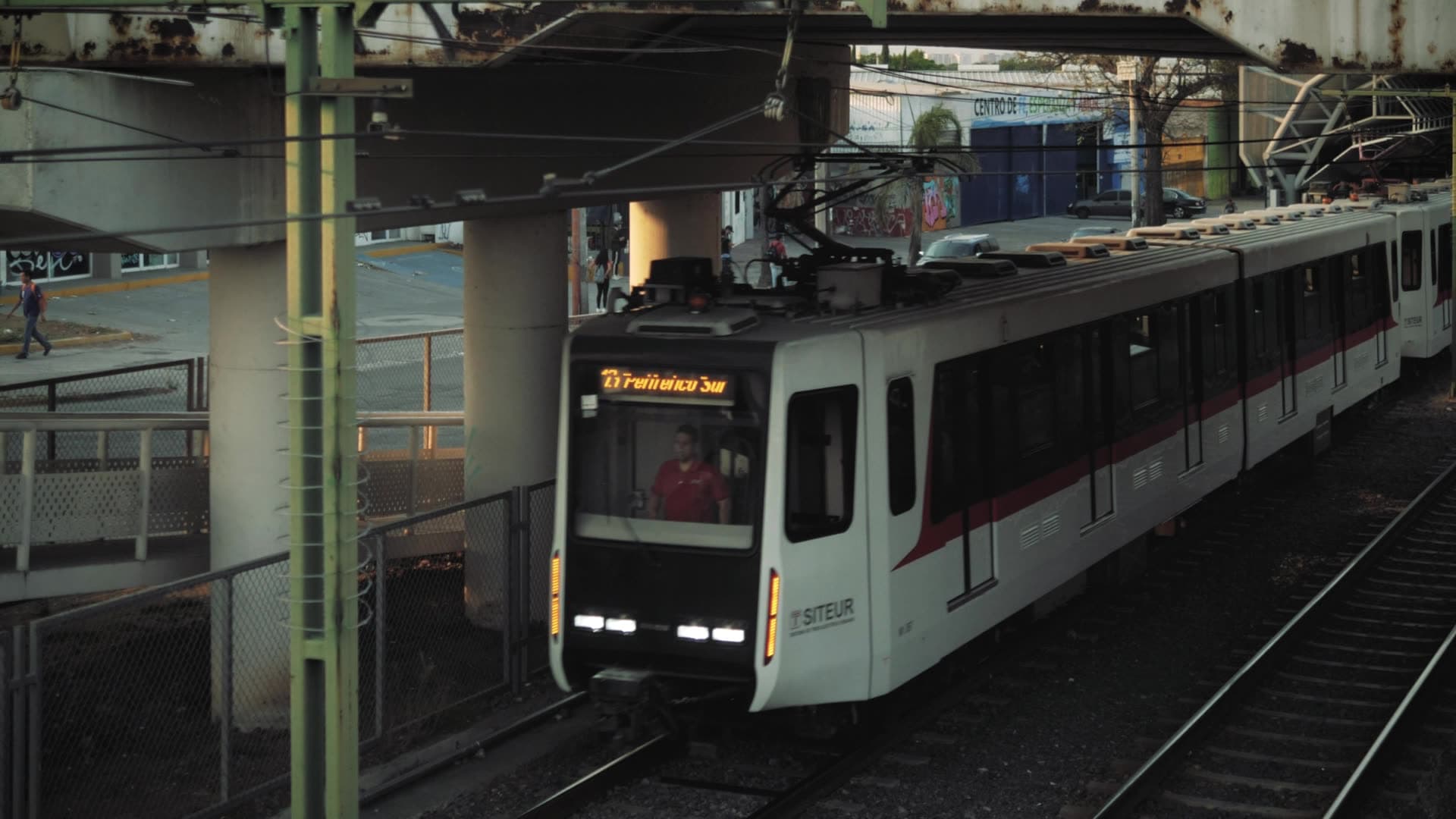 Commuter train passing beneath an elevated station